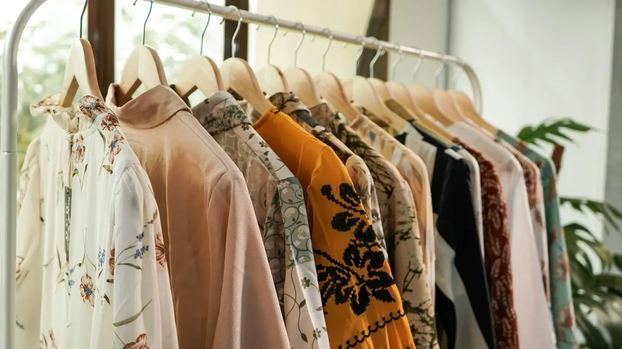 A rack of blouses and shirts on hangers