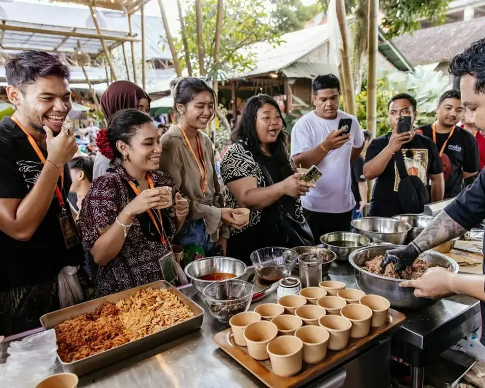 Shoppers tasting samples at a food market stall