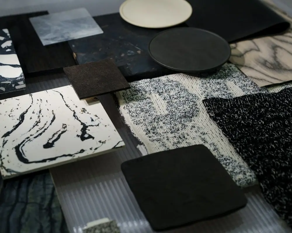 Stone and tile samples laid out on a table