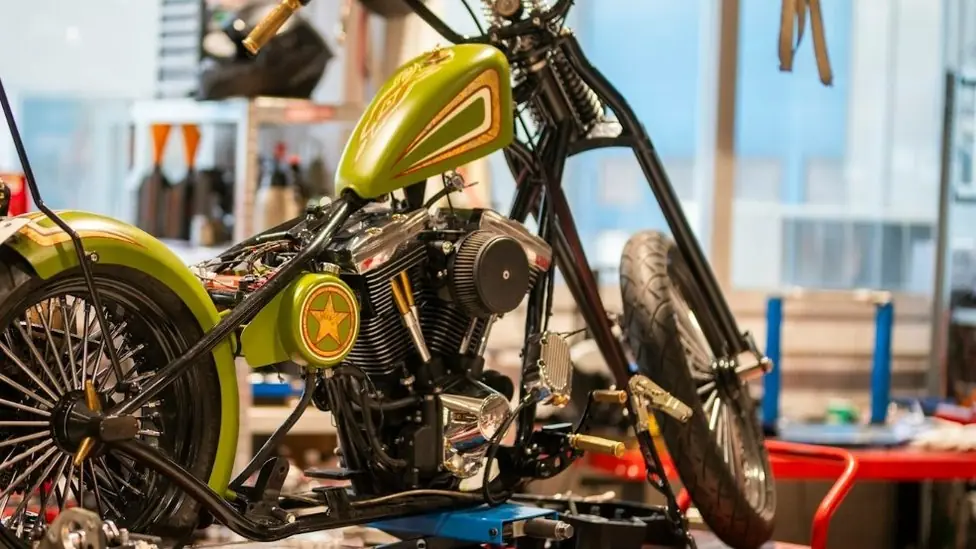 A custom motorcycle on a workshop lift