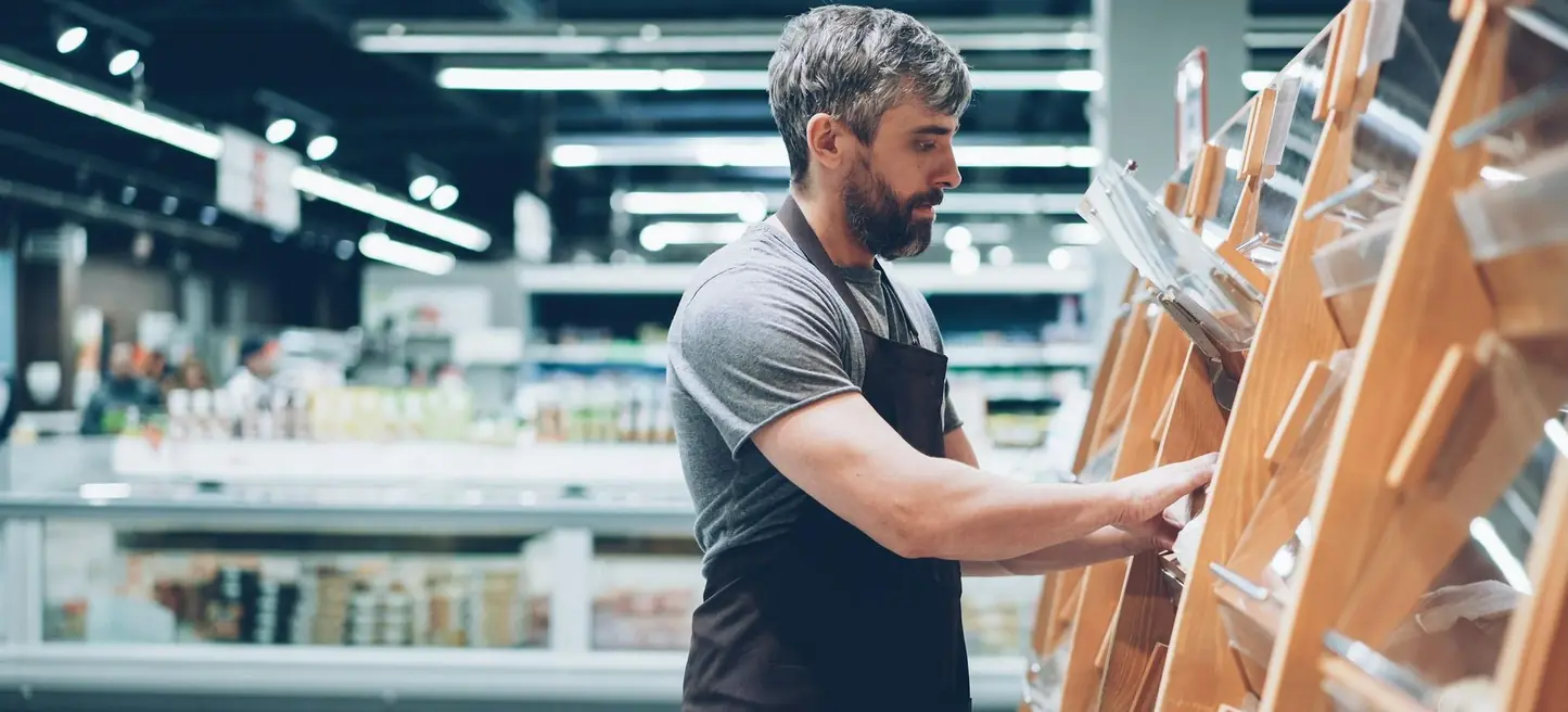 A grocery buyer walking the shelf