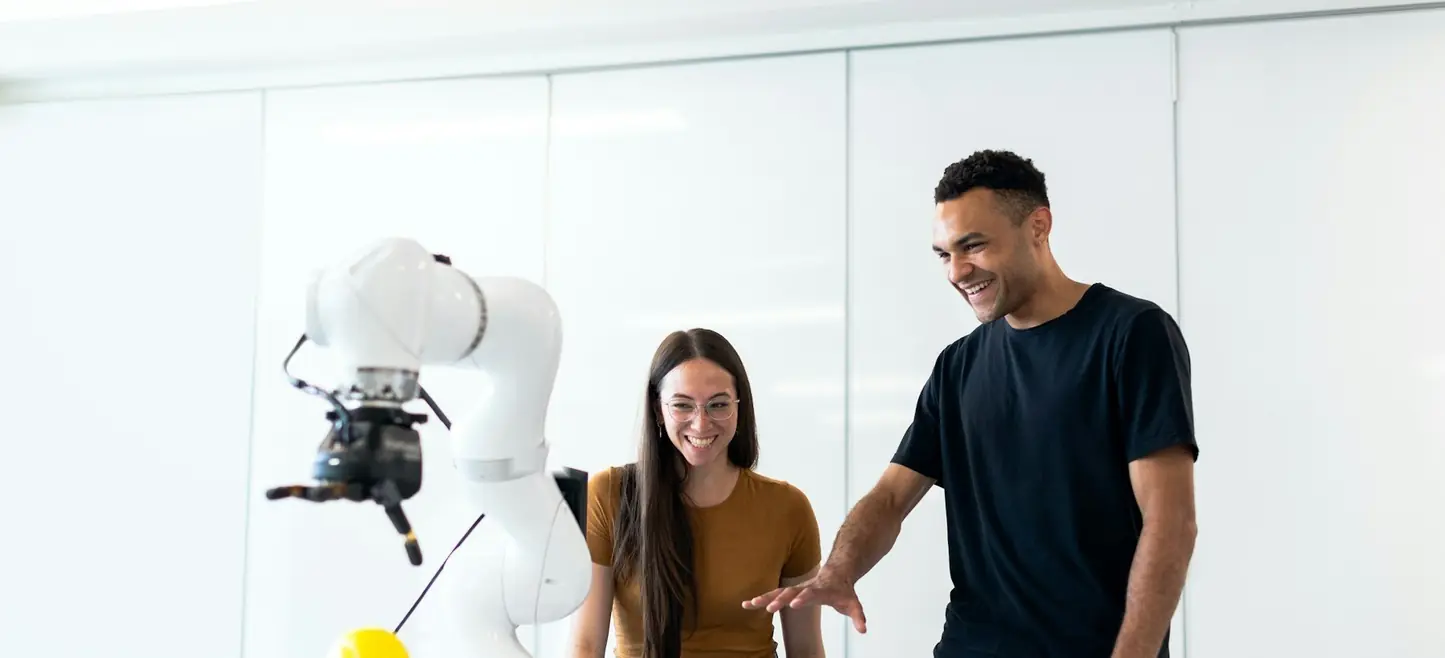 An engineer working on a robot arm