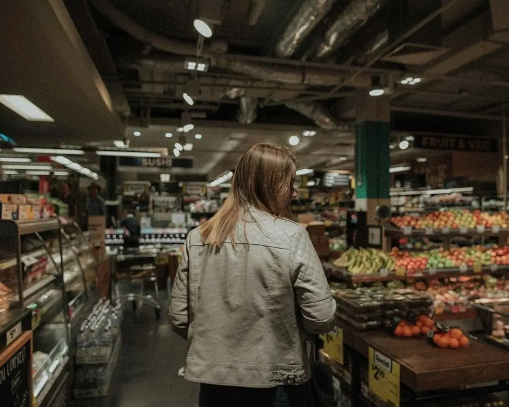 A shopper walking through a grocery store