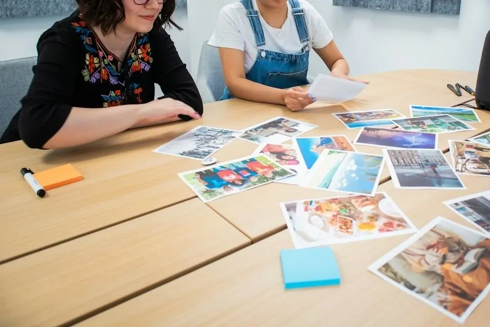 A team sorting printed photos on a table