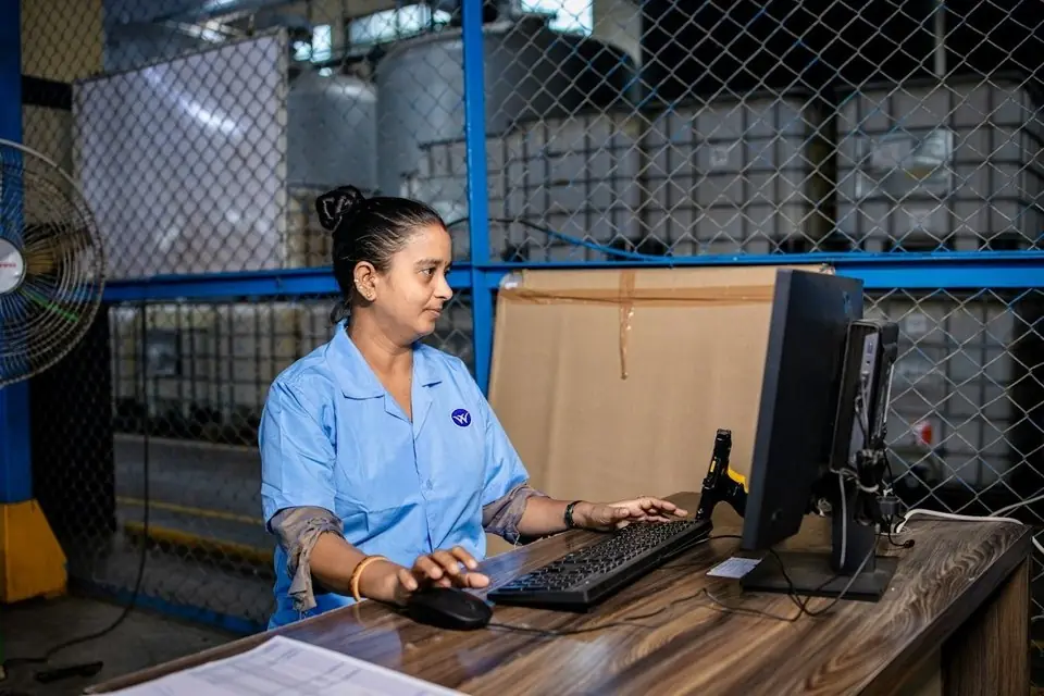 A woman at a computer in a warehouse office