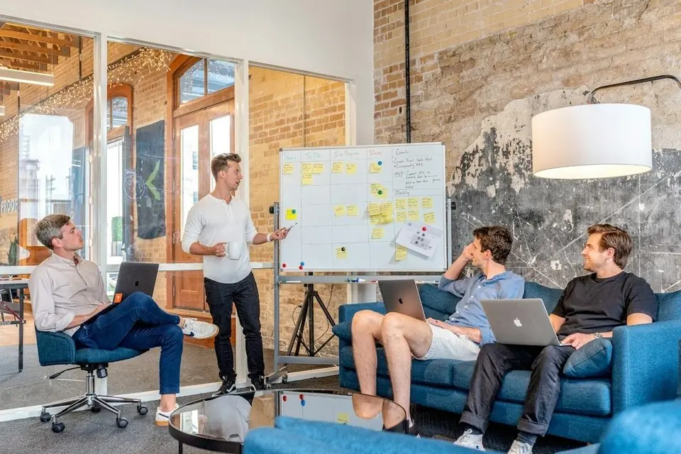 A team reviewing a plan on a whiteboard
