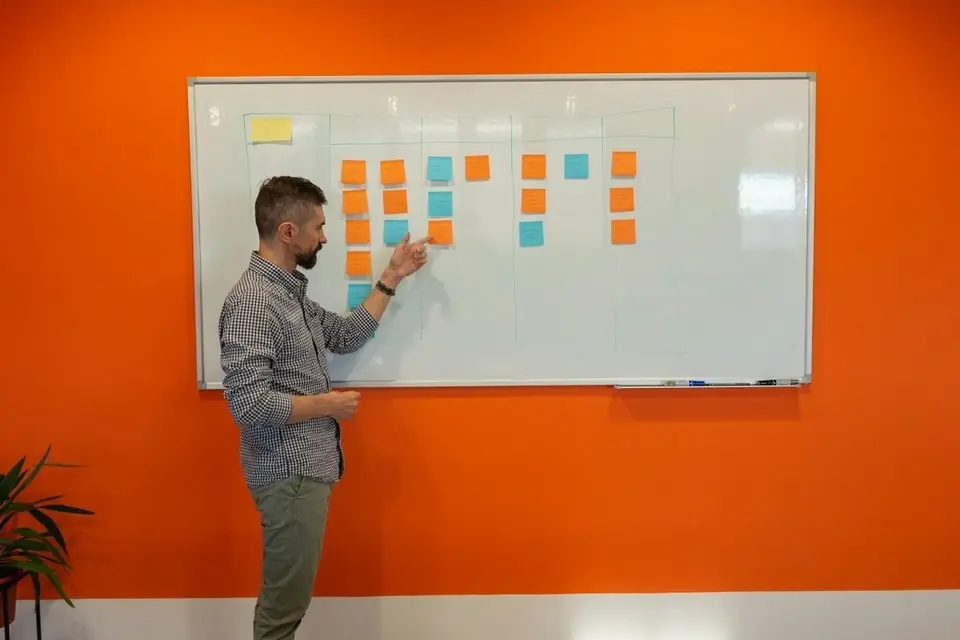 A man planning at a whiteboard of sticky notes